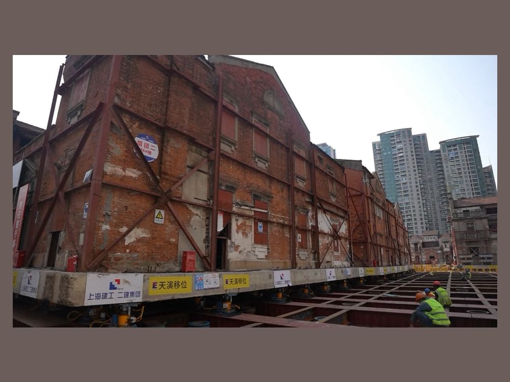Robots move historic Shikumen buildings back to original site in Shanghai